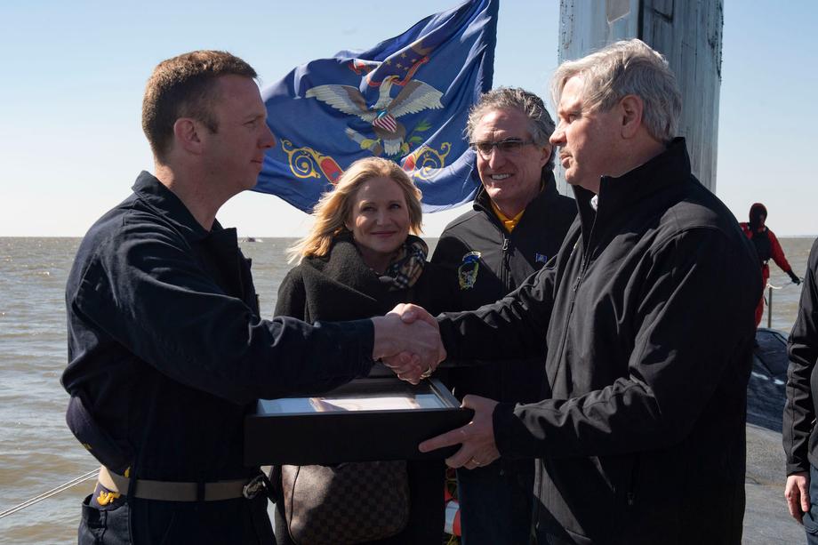 April 2019 - Senator Hoeven presents an American flag flown over the U.S. Capitol to a USS North Dakota crew member.